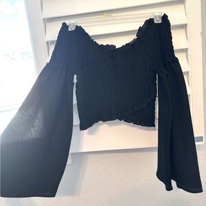 Black off shoulder blouse from Fashion Nova